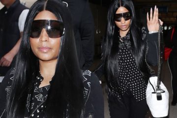 Nicki Minaj sparks pregnancy rumours as she covers stomach with bag after four-month break from the spotlight