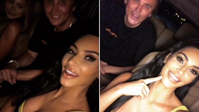 Kim Kardashian puts on a busty display in plunging yellow dress while out with friends